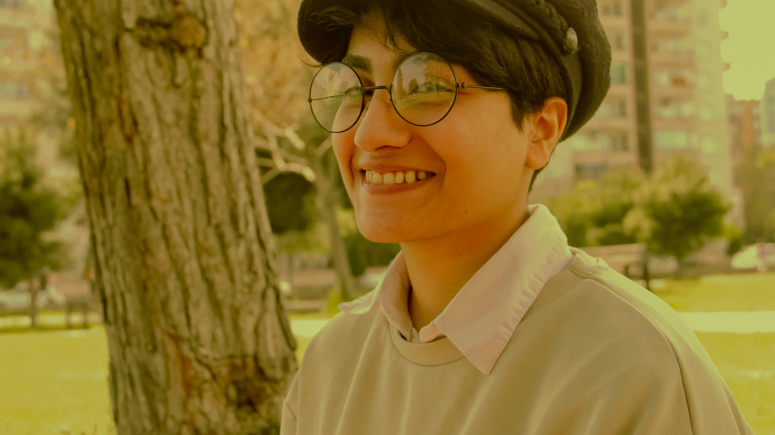 a man in a beanie smiles for the camera