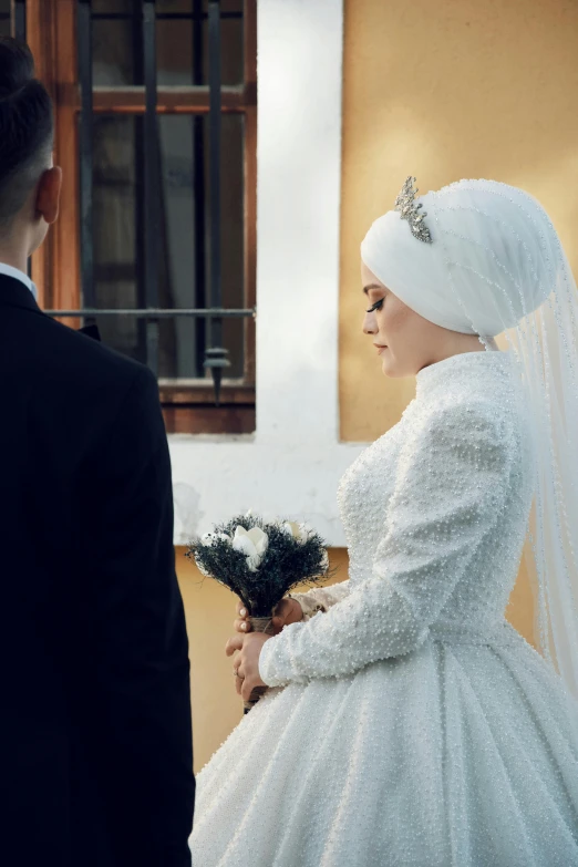 a man and woman standing outside while one woman looks on