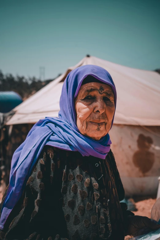 a woman standing in front of a tent