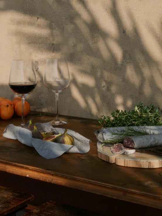 some glasses some food on a wooden table