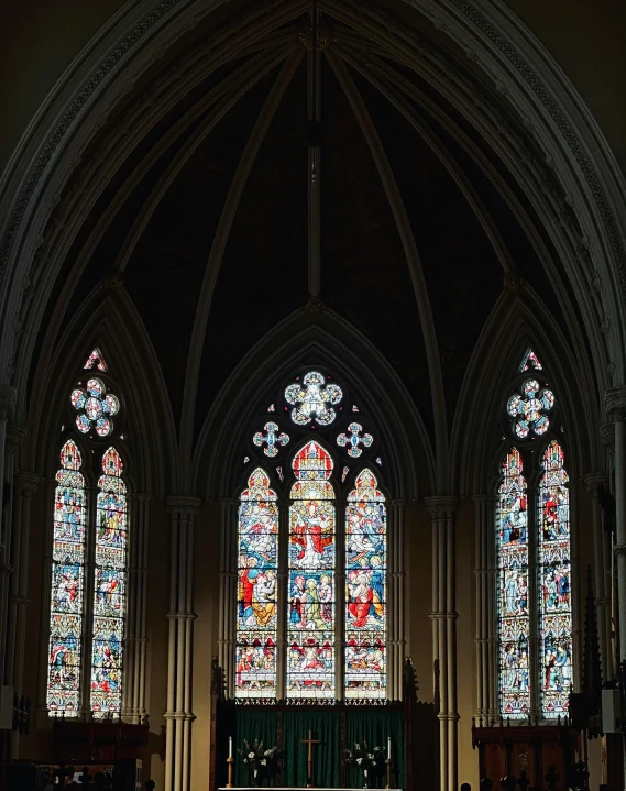 the inside of a cathedral with stained glass windows