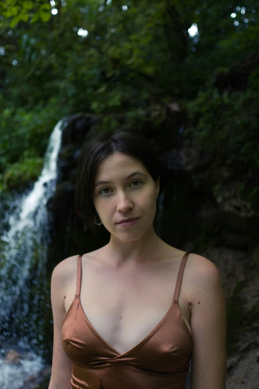 woman with natural  standing at waterfall