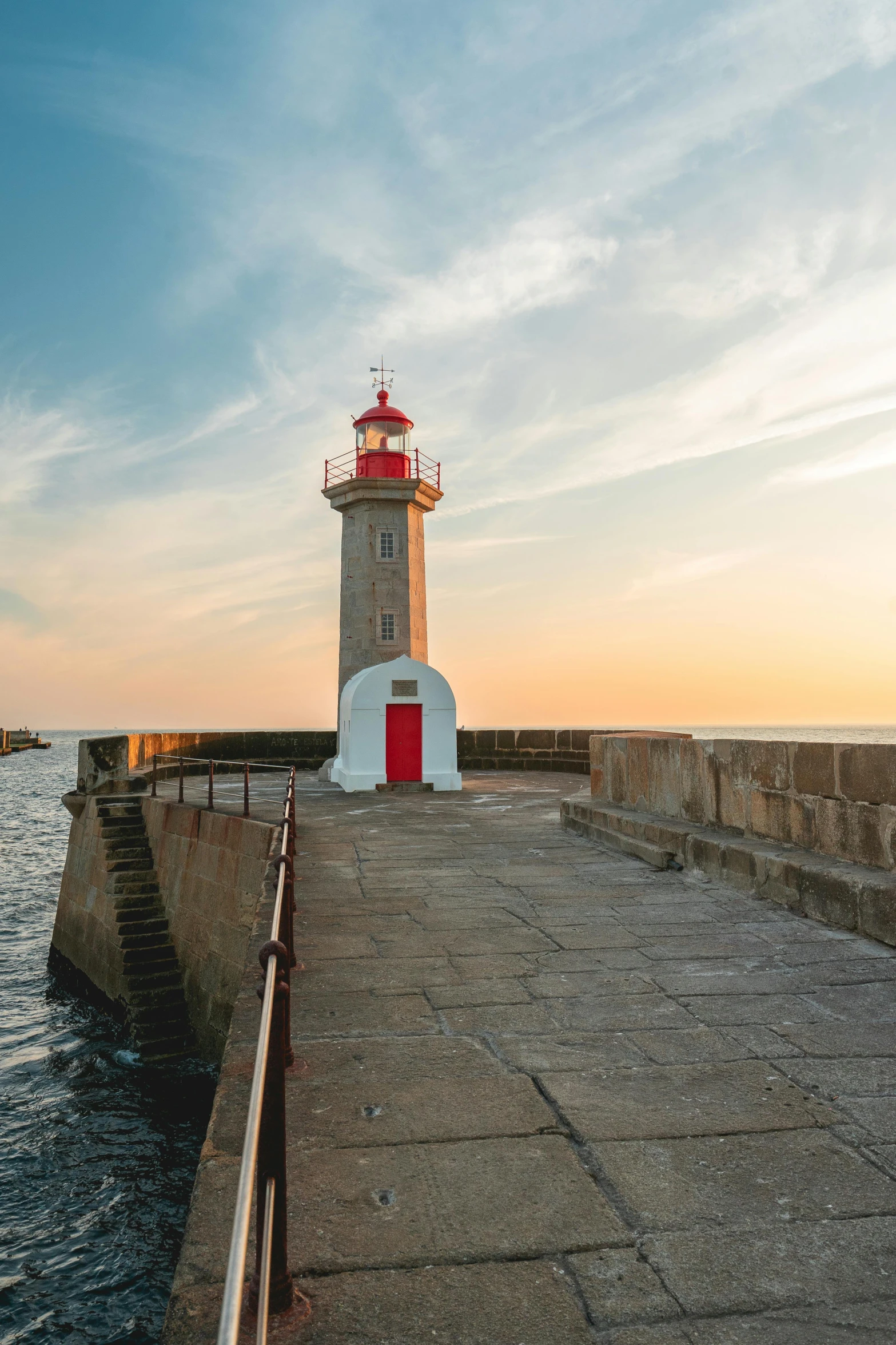 the light house is located on the side of the pier