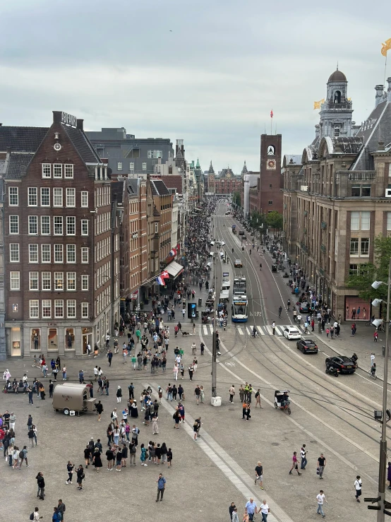 a crowd is gathered around a town square