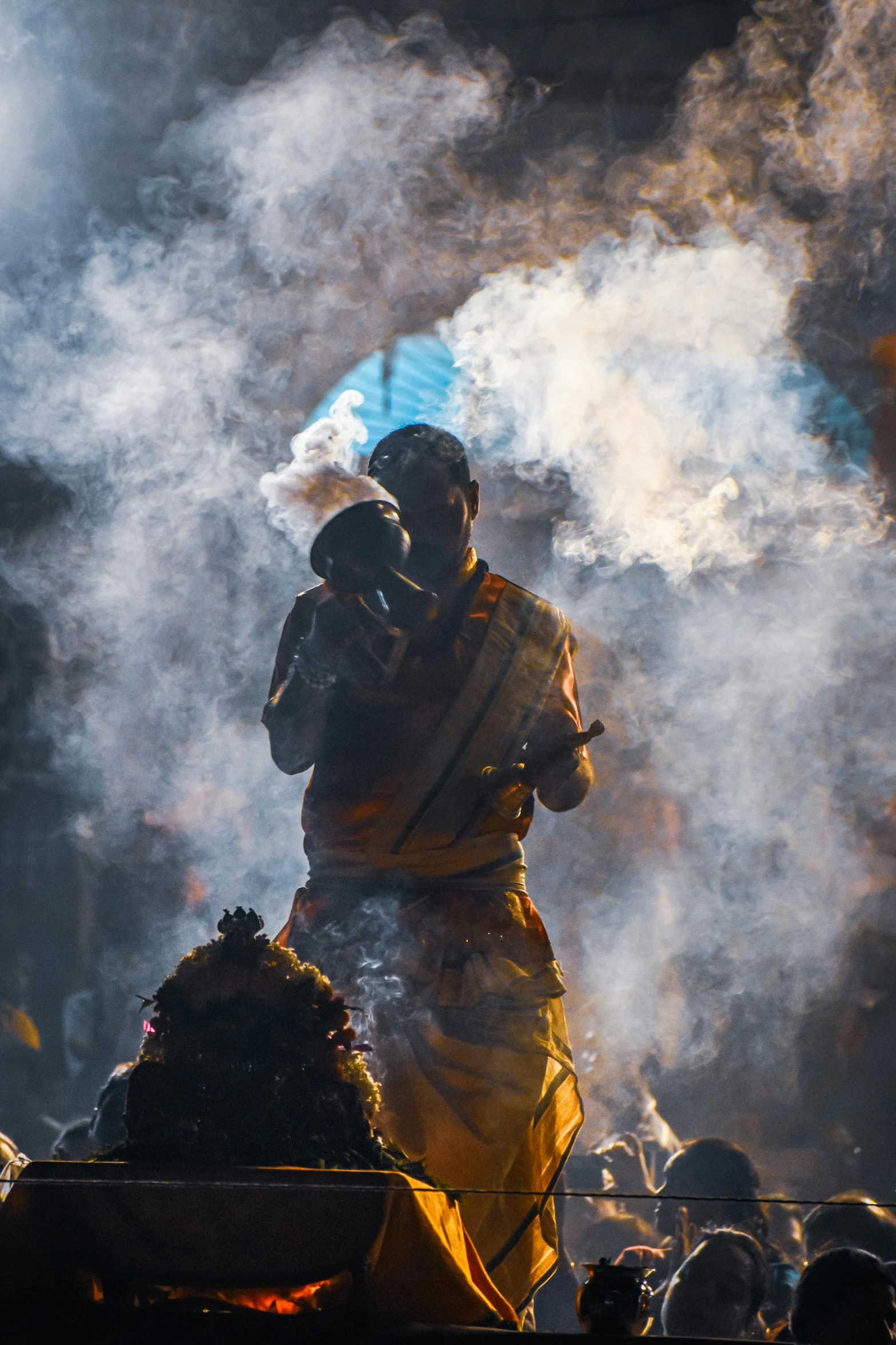 a statue of buddha is surrounded by smoke