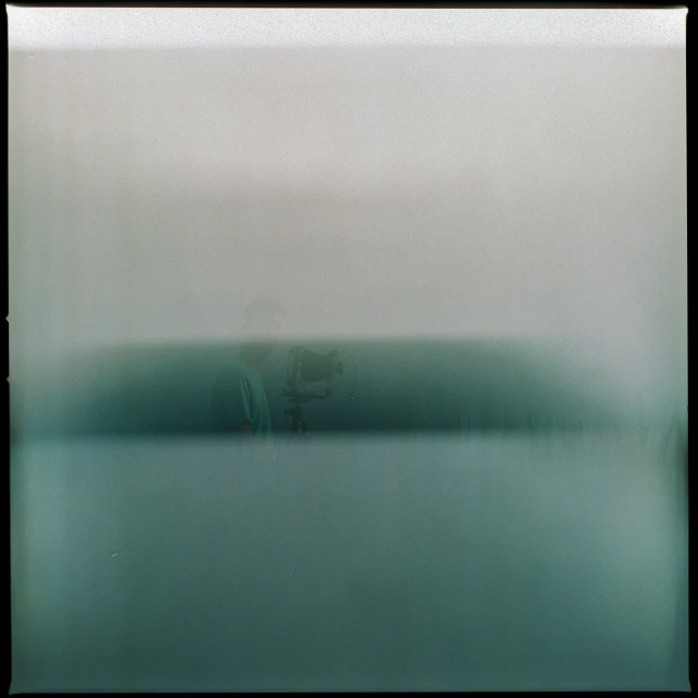 a blurry image of a green and white boat in the water