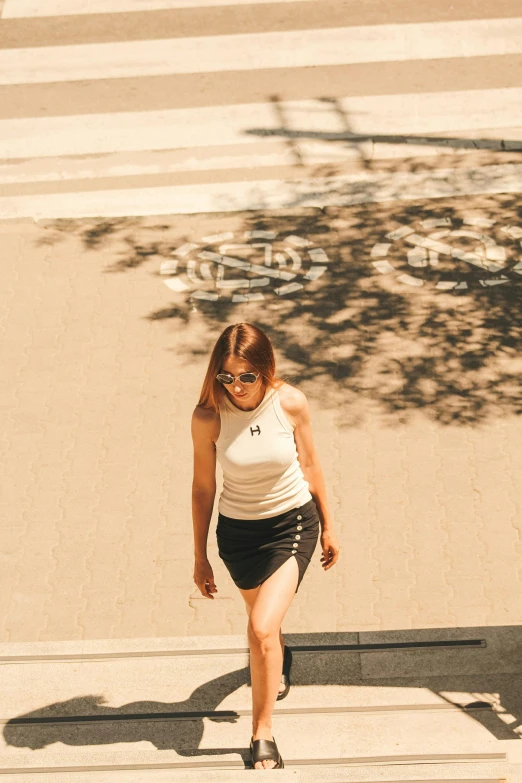 a woman walking across the street near a building