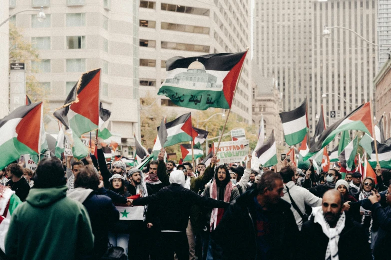 a group of people standing around holding flags