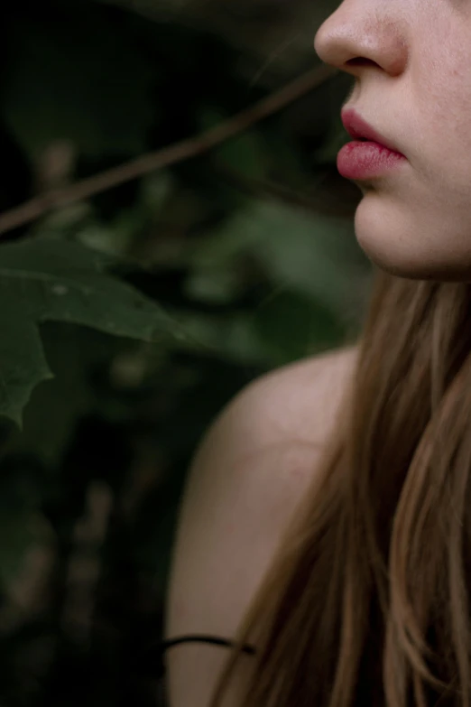 a young woman holding an apple up to her face