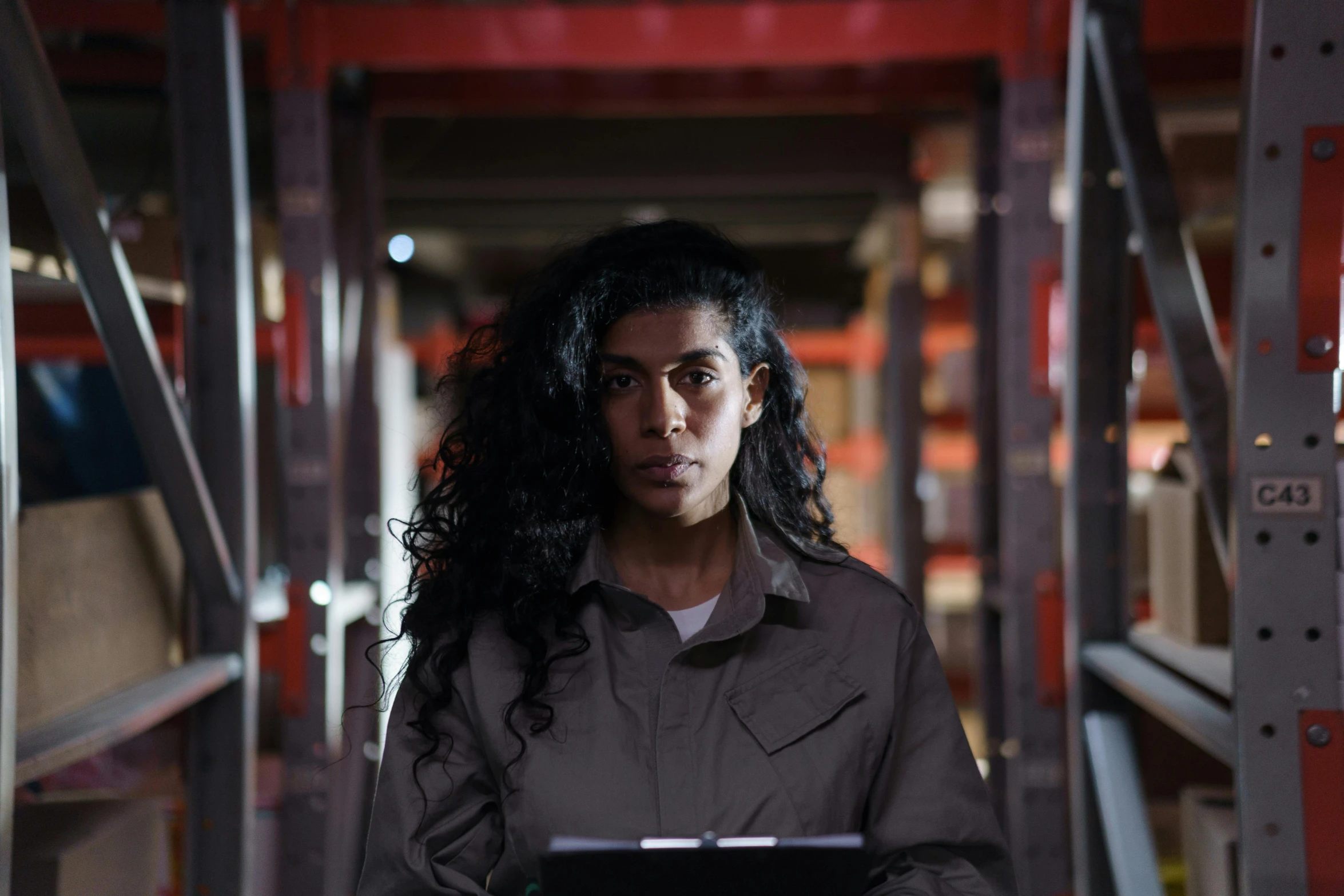 a woman holding a laptop in an industrial setting