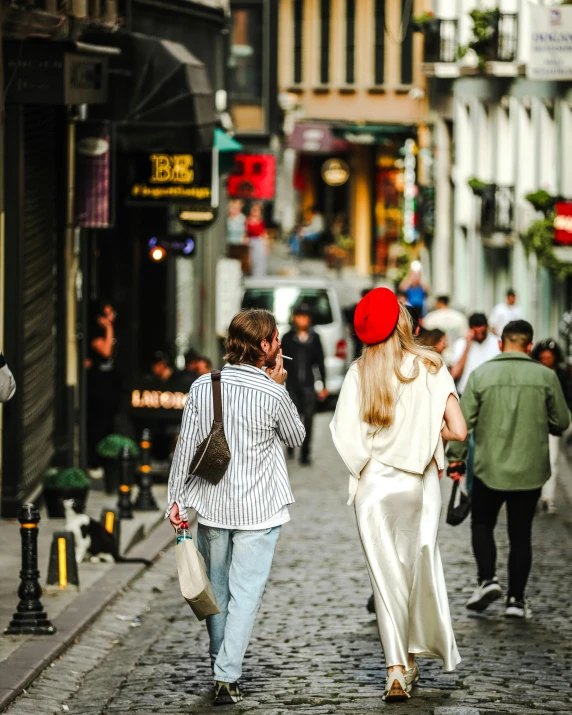 two women walk down a crowded city street