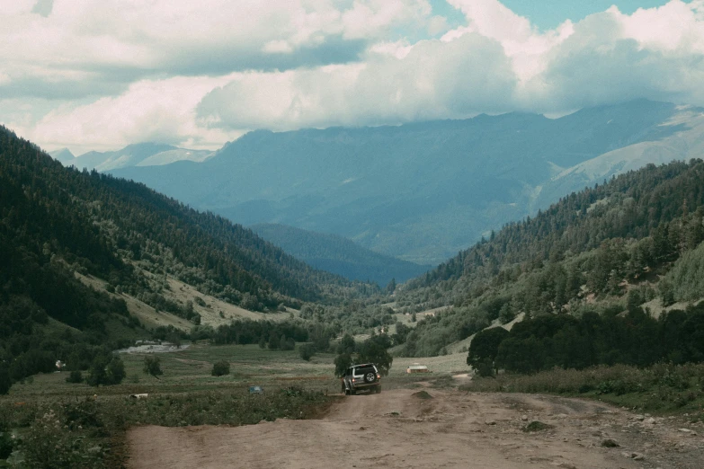 a truck is on the side of the dirt road