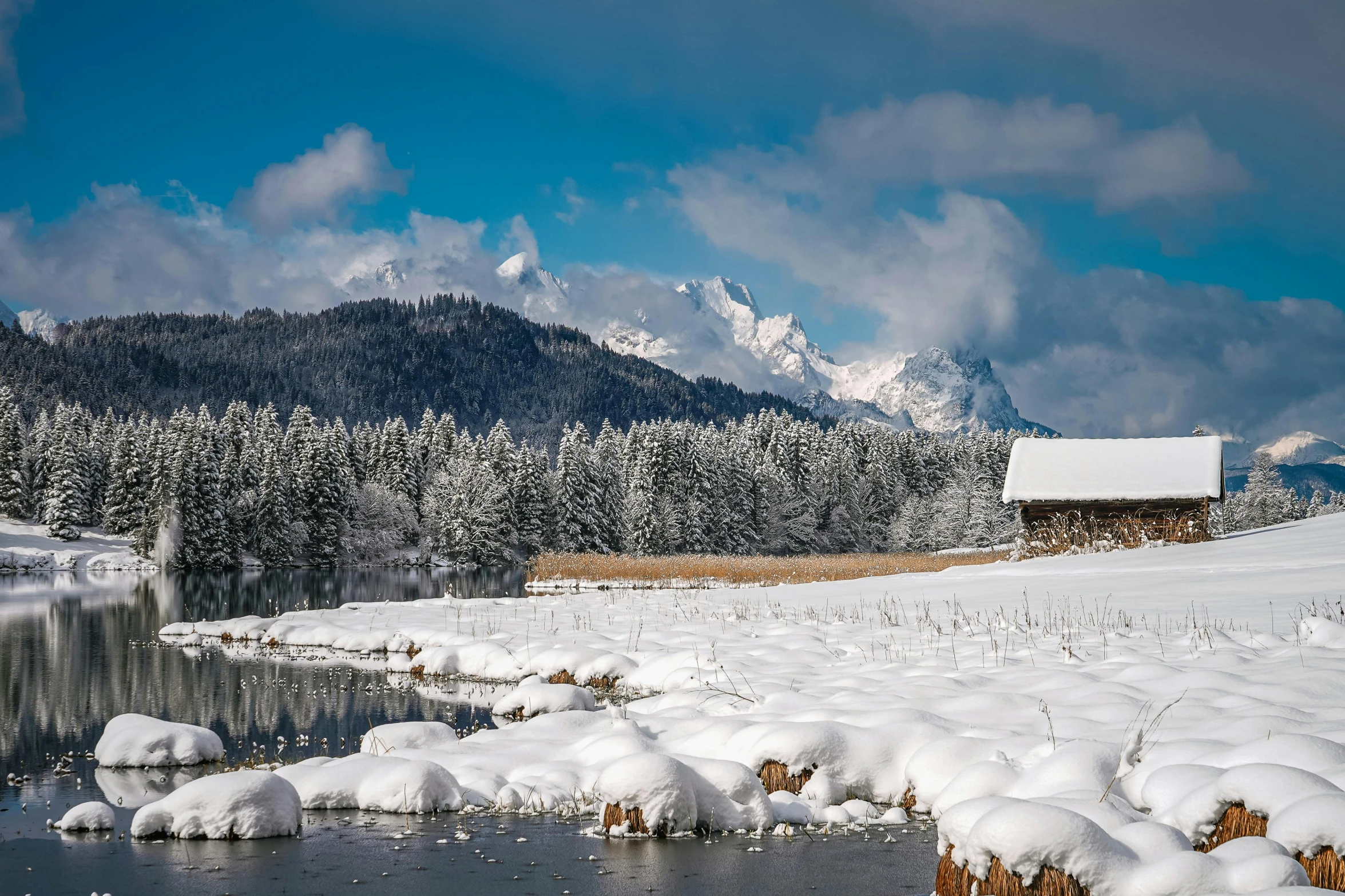 a frozen field and mountains are in the background