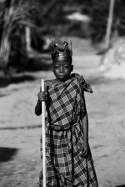 a girl is wearing a costume with a stick