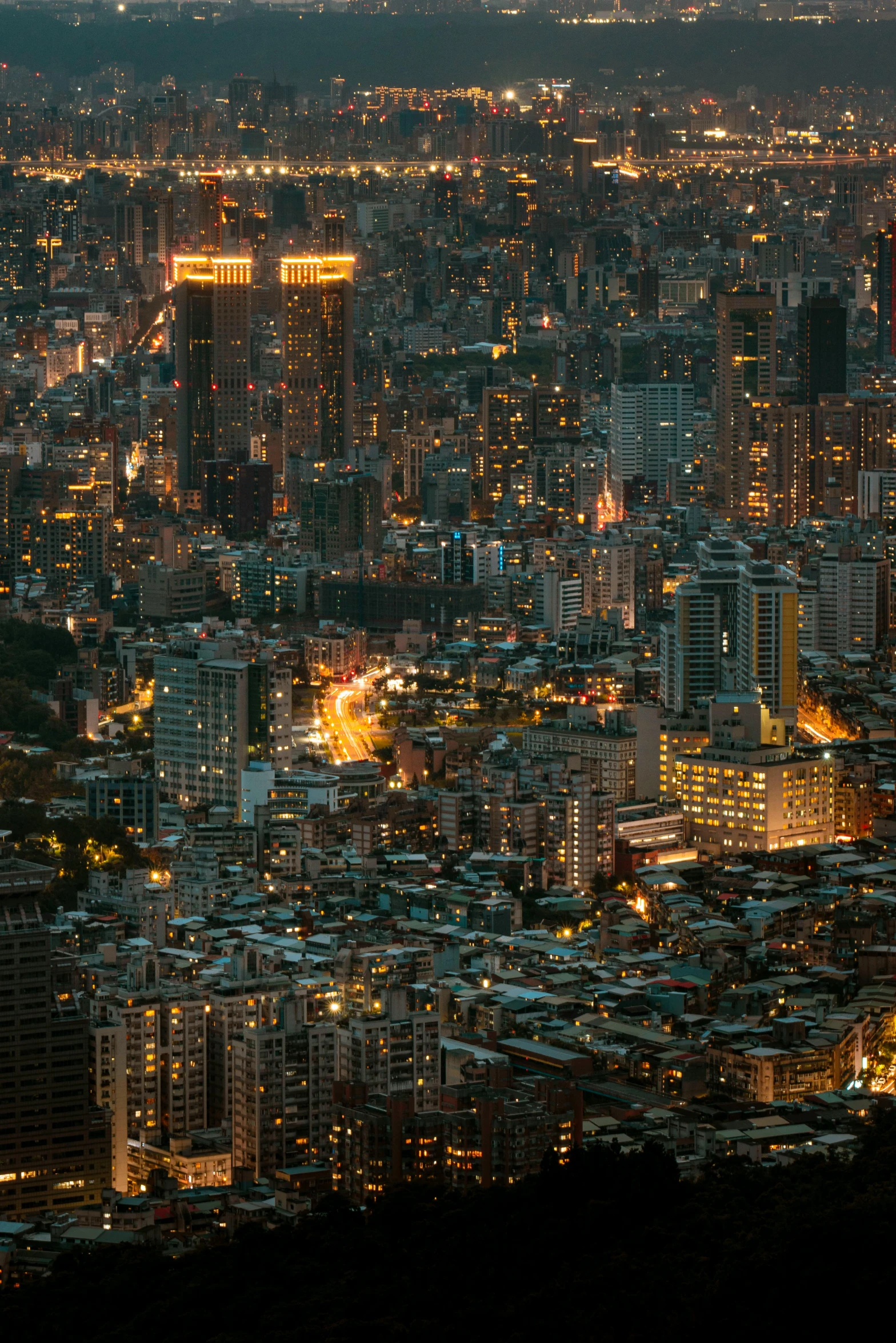 a city filled with tall buildings at night