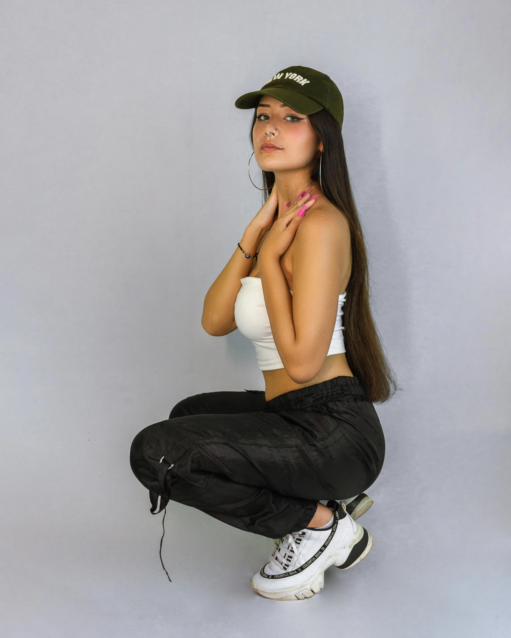 woman in black pants and white shirt sitting on top of a chair