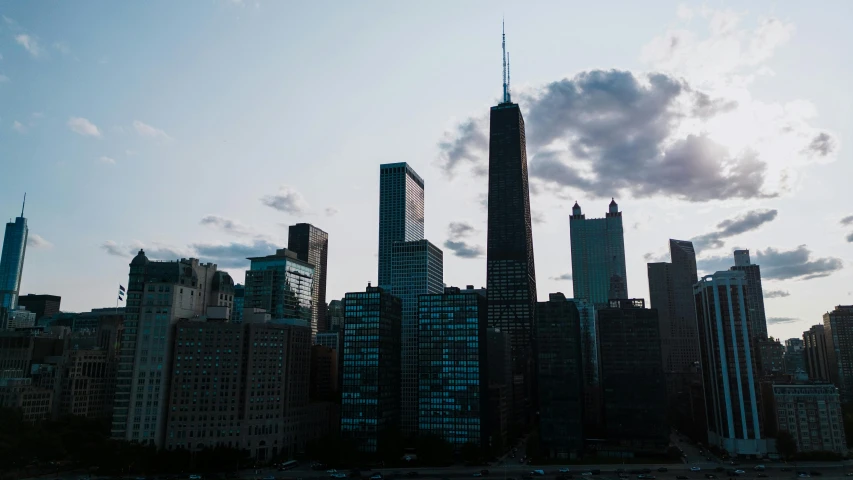 the skyscrs in manhattan at dusk are lit up