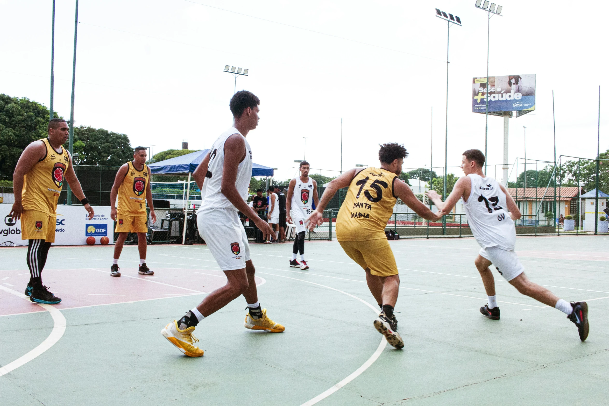 men on a court playing basketball with an audience watching