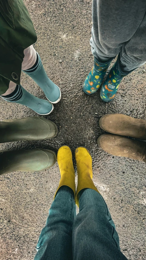 the feet of people standing in the middle of the road