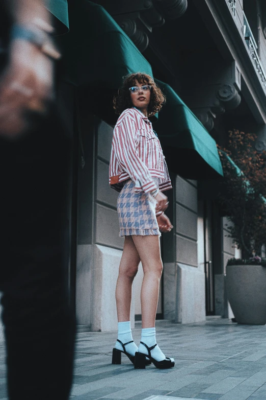 a young woman poses for a po while wearing short shorts