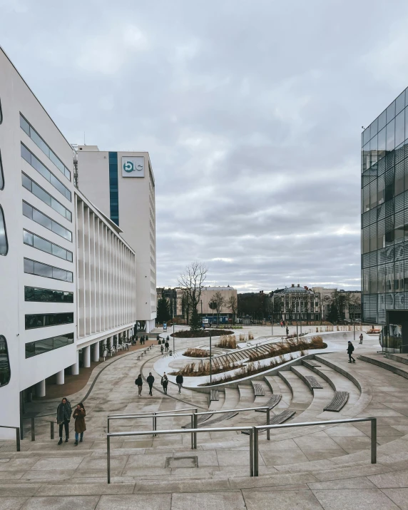 some people walking on a concrete floor near building