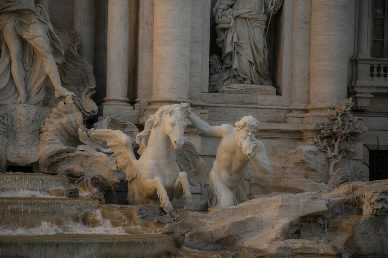 three statues on each side of the fountain