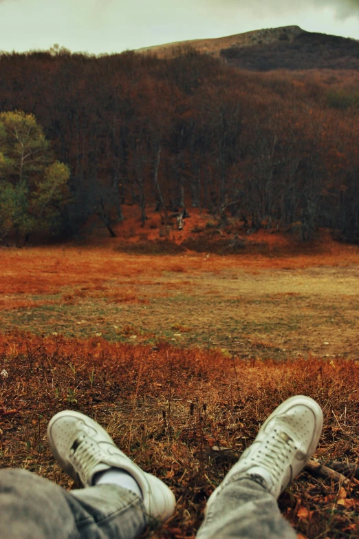 a person with their feet propped against a pole