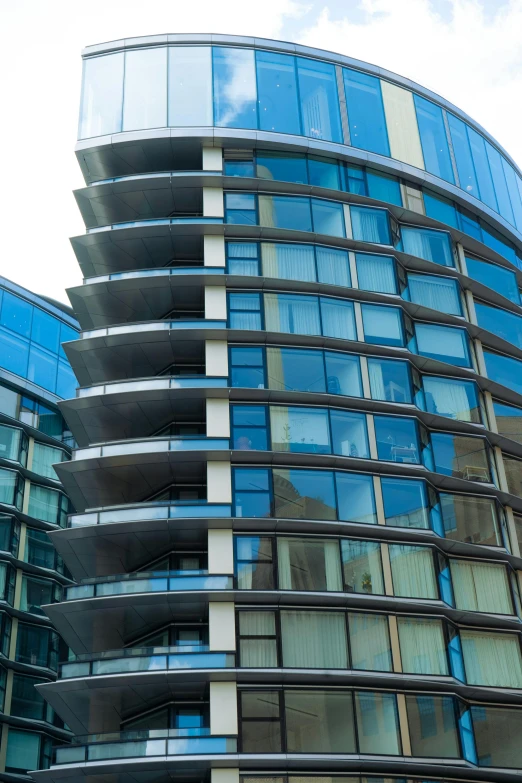 a glass building with several levels that look like a wave