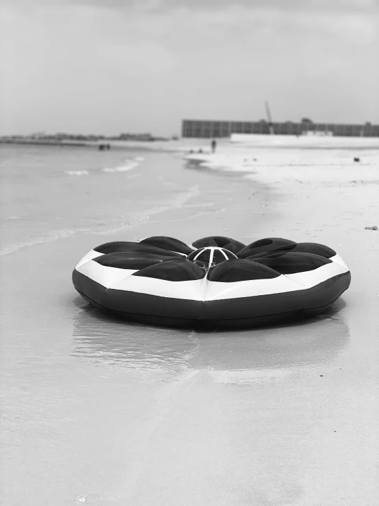 a raft sitting on top of an ocean next to the beach