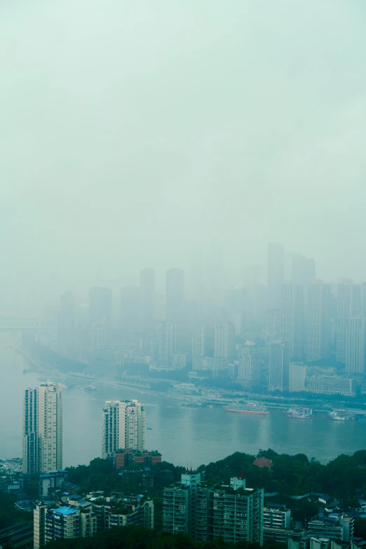 a big city next to the ocean in heavy fog