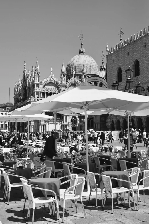 some tables with chairs and an umbrella over