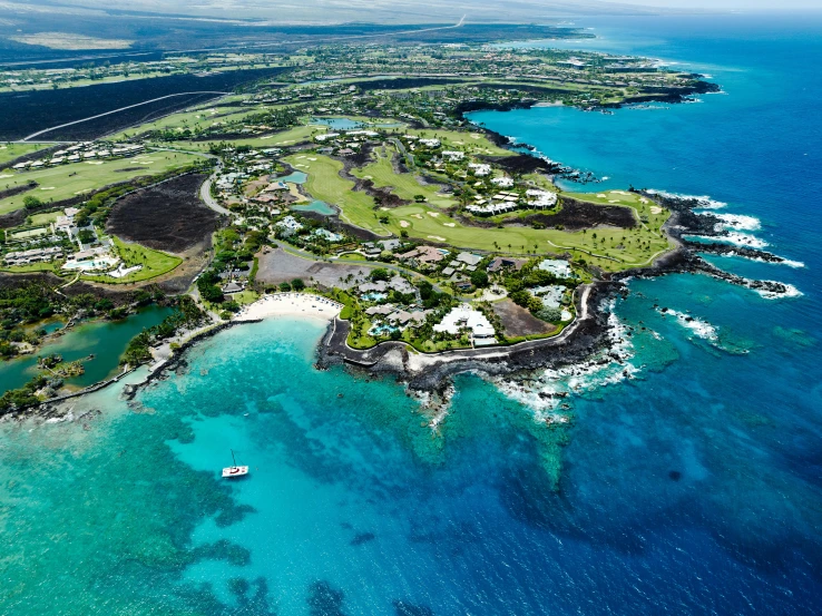 a small island surrounded by the ocean and lots of blue water