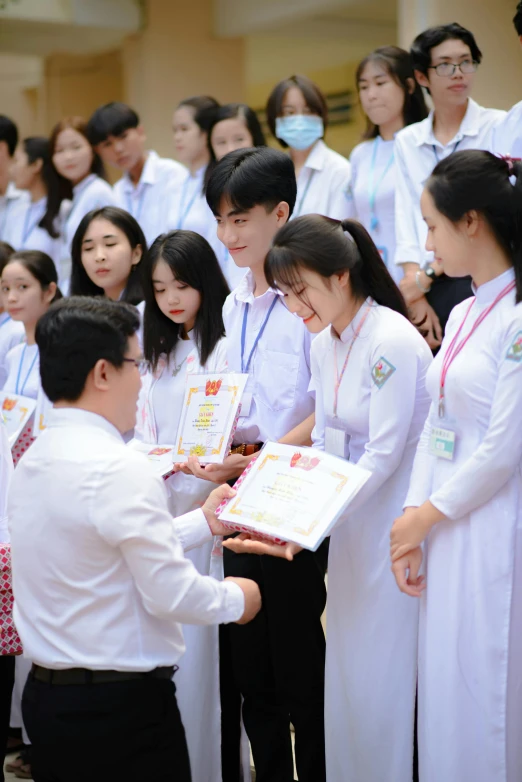 a man and two women holding up pamphlets