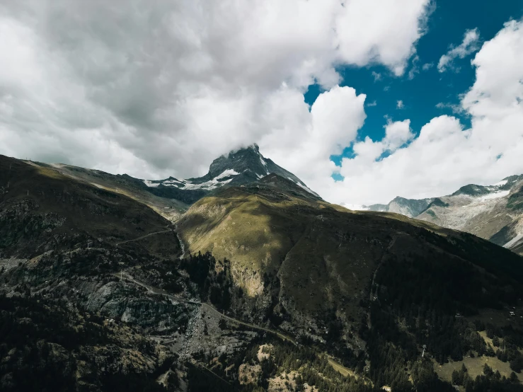 mountains in the background with some clouds and blue sky