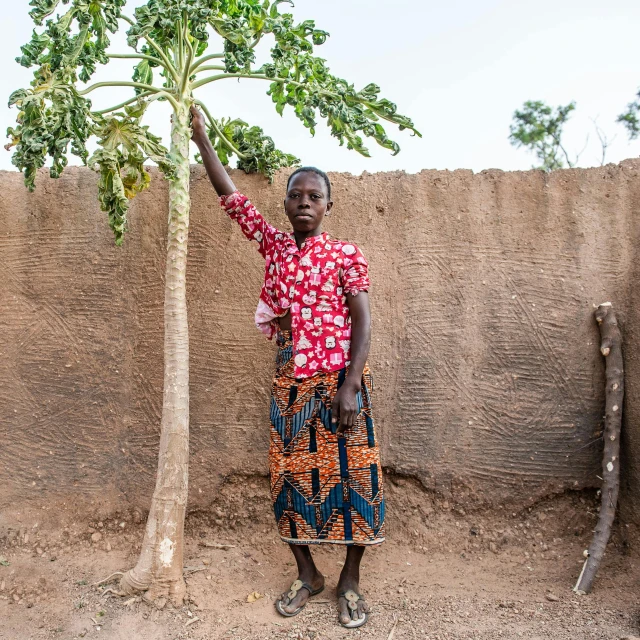 a person that is standing near a tree