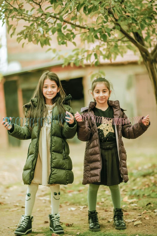 two little girls playing in the woods in winter