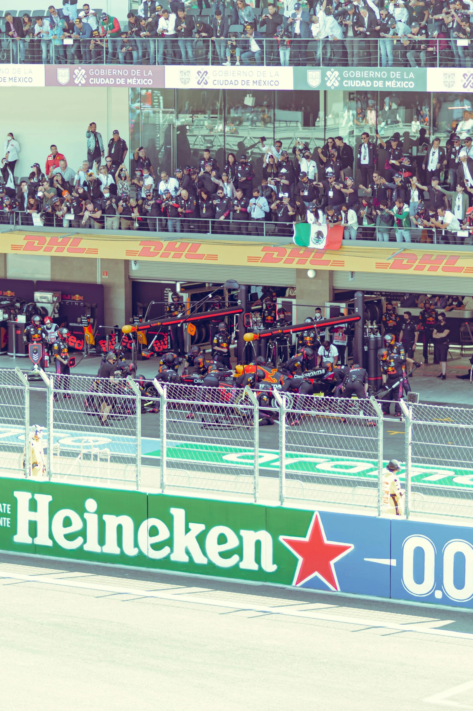 spectators sit in stands watching a race