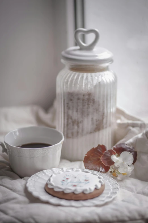 a cookie sitting next to a cup of coffee