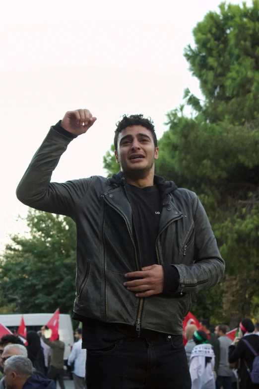 a man standing with his fist raised in the air