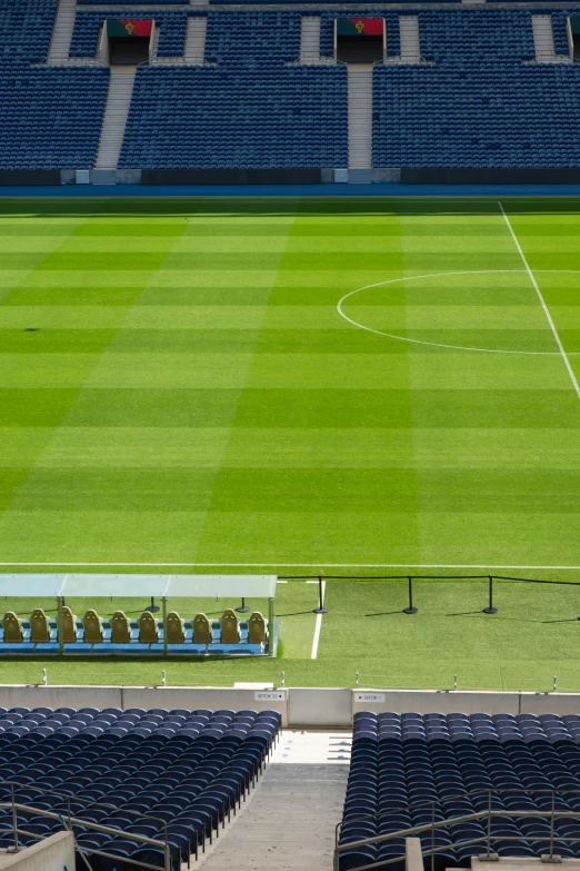 an empty stadium field with seats and the lights turned on