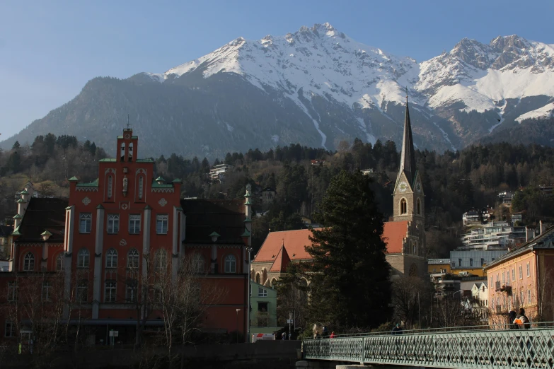 a beautiful city with a castle like building near a mountain range