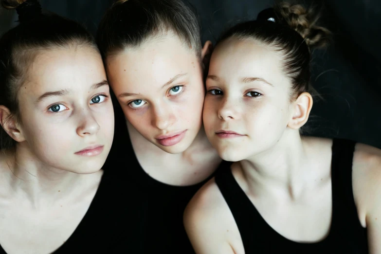 three female students are posing for the camera