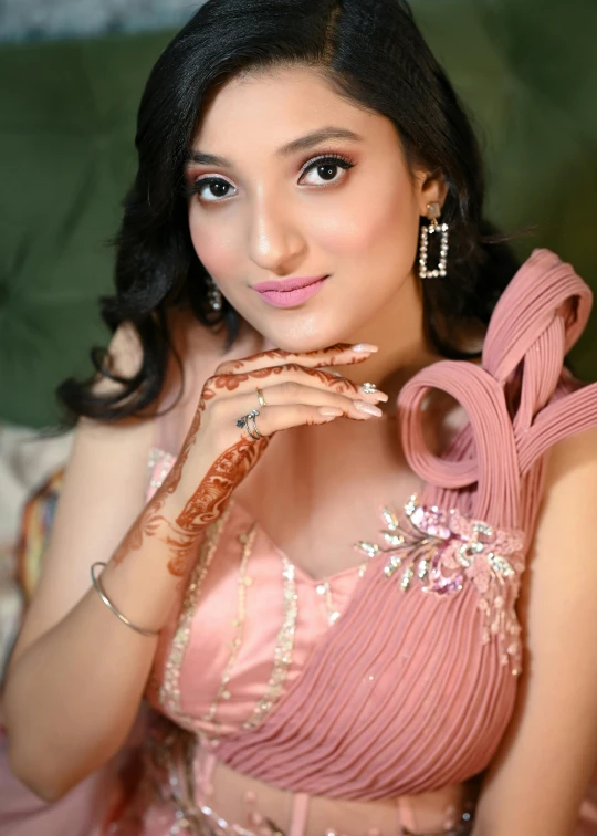 a beautiful young lady wearing a pink dress with a bow