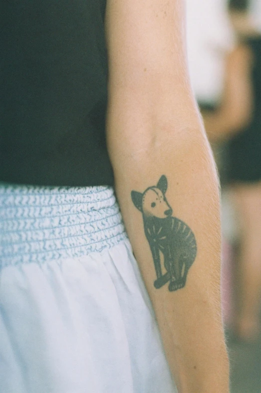 a person has a tattoo with a bear on their arm