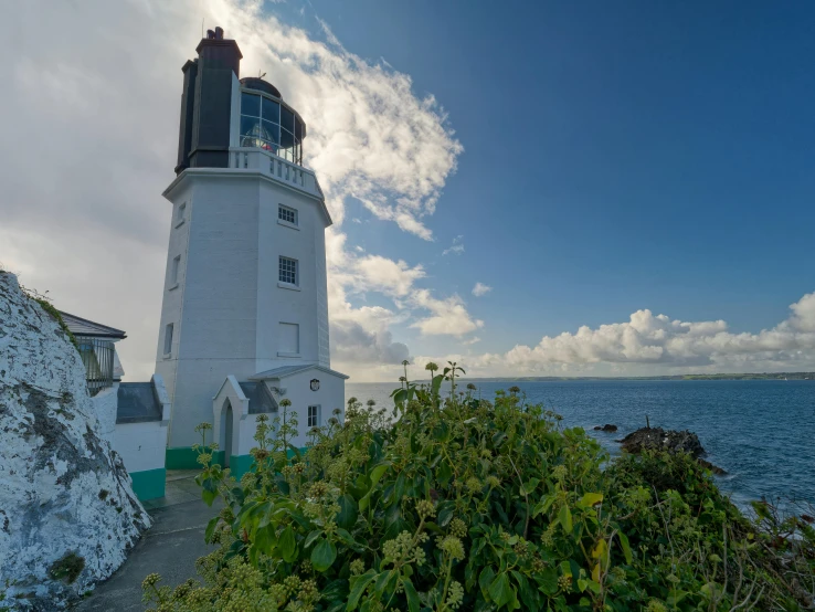 the ocean and lighthouse is shown at the beach