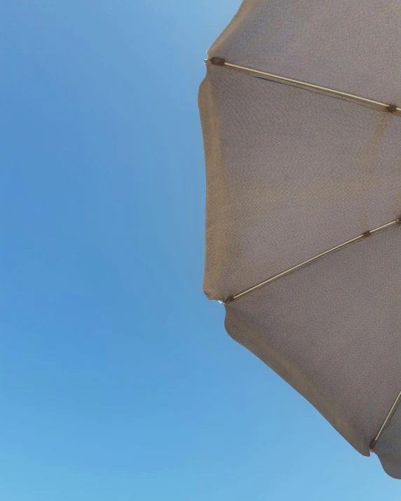 an umbrella and some blue sky in the day