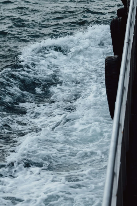 a man holding onto some kind of soing while standing on a ferry boat