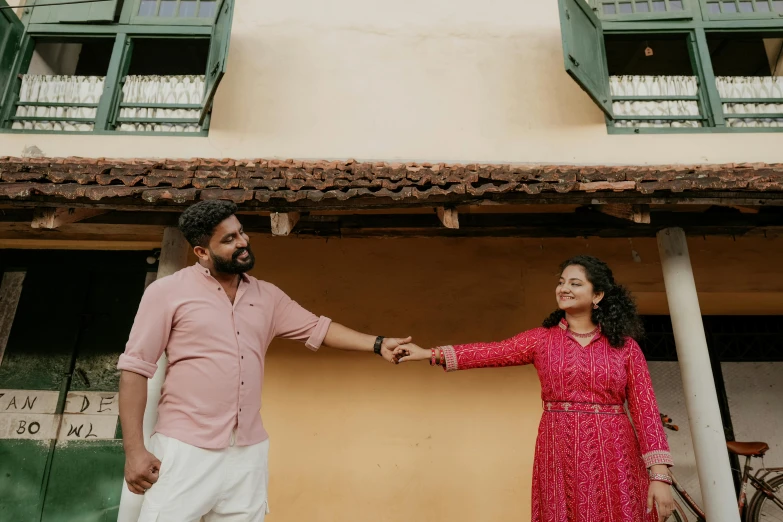 a man standing next to a woman on a street