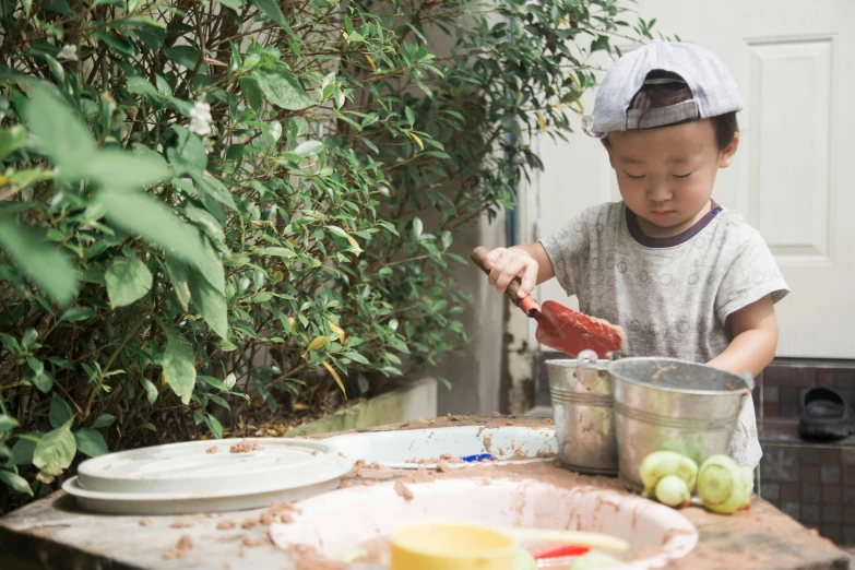 a little boy making a sandwich on a table