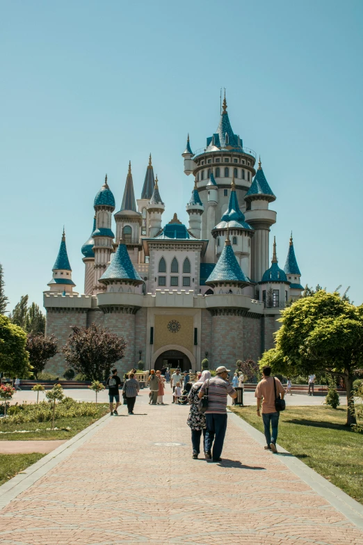 there are people that are walking in front of a castle